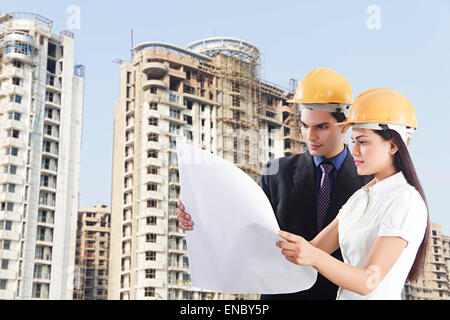 2 indian Engineer Colleague Concentration site map Checking Stock Photo