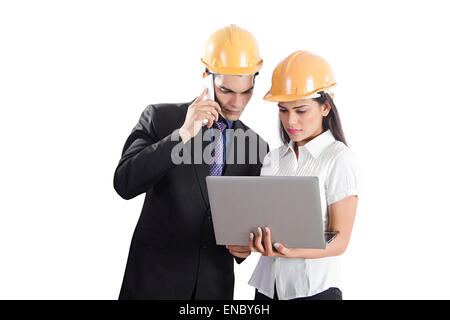 2 indian Engineer Colleague Project Laptop Checking and talking phone Stock Photo