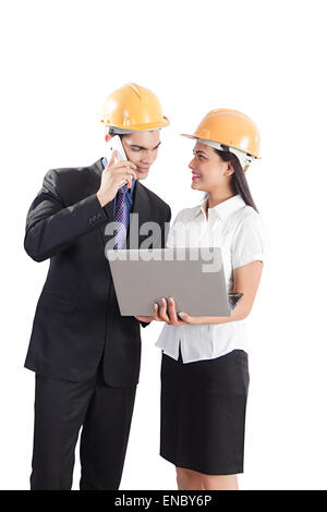 2 indian Engineer Colleague Project Laptop Checking and talking phone Stock Photo