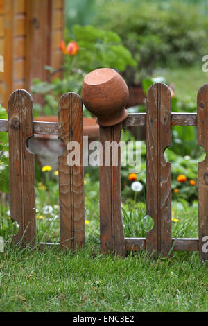 Old traditional clay jug hanging on the wooden fence Stock Photo