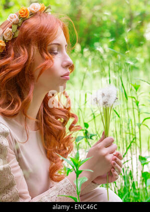 Portrait of nice dreamy woman on fresh green field with dandelion flower bouquet, having fun in the park, enjoy spring nature Stock Photo