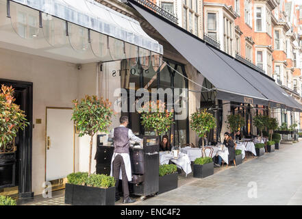 Scott's of Mayfair, famous high class, expensive, fine dining restaurant, Mayfair. London W1: street view, exterior, outside tables, awning and waiter Stock Photo