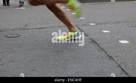 Detail of legs and shoes of a 2015 London Marathon runner running along Upper Thames Street London UK KATHY DEWITT Stock Photo