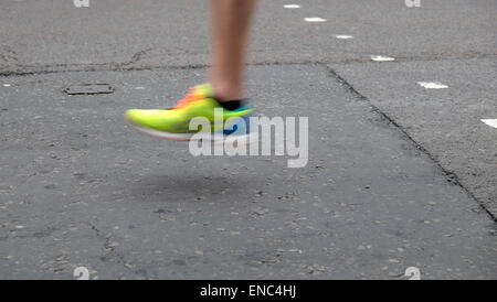 Detail of leg and shoe of 2015 London Marathon competitor running along Upper Thames Street London UK KATHY DEWITT Stock Photo