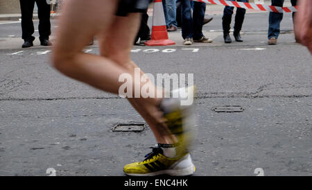 Detail of legs and shoes of 2015 London Marathon competitor running along Upper Thames Street London UK KATHY DEWITT Stock Photo