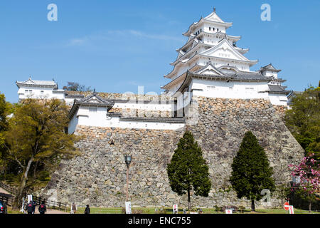 One of the most popular tourist destinations in Japan, Himeji castle. The  restored keep with the Obi Yagura, turret, in front and blue sky behind. Stock Photo