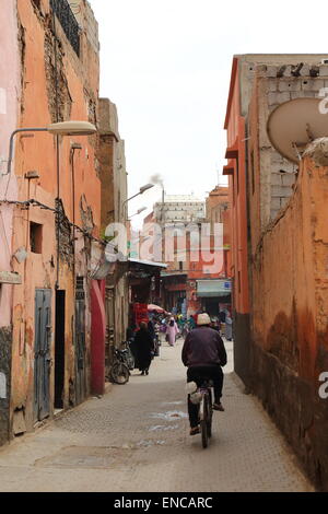 A typical street scene in Marrakech, Morocco with pedestrians and a cyclist Stock Photo