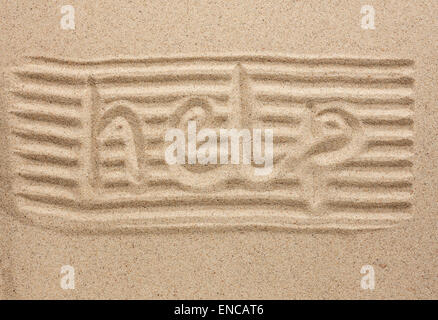 Word help written in the sand, as a background Stock Photo