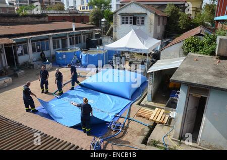 HANDOUT - A handout picture, made available on 02 May 2015 by the German Federal Agency for Technical Relief (Technisches Hilfswerk, THW), shows THW workers setting up the first of two drinking water purification devices at local water supply facilities in Kathmandu, Nepal, 30 April 2015. After the successful trial operation of the devices and subsequent laboratory testing, the first batches of water were distributed to local residents on 02 May 2015. PHOTO: THW/dpa ( - MANDATORY CREDIT: Photo: THW/dpa) Stock Photo