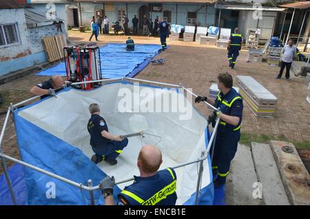 HANDOUT - A handout picture, made available on 02 May 2015 by the German Federal Agency for Technical Relief (Technisches Hilfswerk, THW), shows THW workers setting up the first of two drinking water purification devices at local water supply facilities in Kathmandu, Nepal, 30 April 2015. After the successful trial operation of the devices and subsequent laboratory testing, the first batches of water were distributed to local residents on 02 May 2015. PHOTO: THW/dpa ( - MANDATORY CREDIT: Photo: THW/dpa) Stock Photo