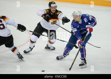 Prague, Czech Republic. 02nd May, 2015. Germany's Moritz Mueller (C) and France's Stephane Da Costa vie for the puck during the Ice Hockey World Championship match between France and Germany in the O2 Arena in Prague, Czech Republic, 02 May 2015. Photo: ARMIN WEIGEL/dpa/Alamy Live News Stock Photo
