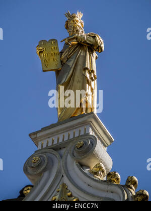 Golden Statue of Moses with 10 commandments on top of Bruges Town City Hall Stock Photo