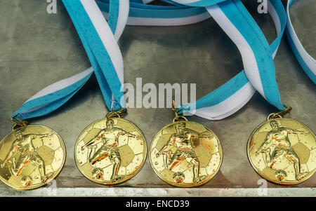 medals,gold medal,football,league,winning,sport,competition,drops,rain,junior,youth,success,award,games,victory,ribbon,first,top Stock Photo