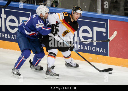 Prague, Czech Republic. 02nd May, 2015. France's Laurent Meunier (L) and Germany's Brent Raedeke vie for the puck during the Ice Hockey World Championship match between France and Germany in the O2 Arena in Prague, Czech Republic, 02 May 2015. Photo: ARMIN WEIGEL/dpa/Alamy Live News Stock Photo
