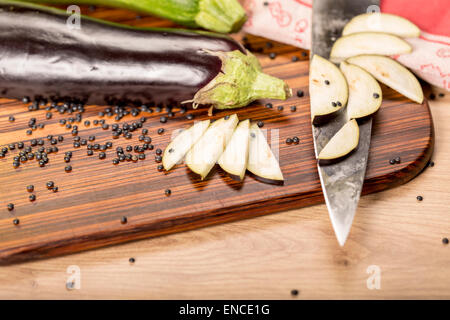 still life with cutted eggplant slices, kitchen knife Stock Photo