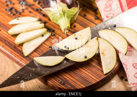 still life with cutted eggplant slices, kitchen knife Stock Photo