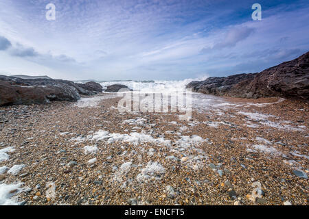 pentireglaze haven cornwall england uk pebbles on the beach with waves crashing in Stock Photo