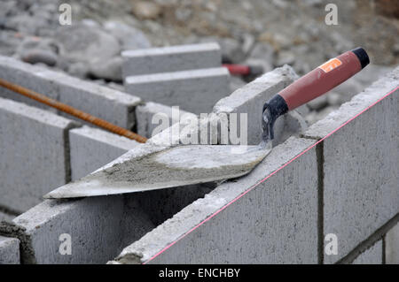Building tools left on concrete block wall Stock Photo