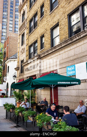 Chicago Illinois,Near North Side,neighborhood,Starbucks Coffee,barista,cafe,sidewalk,table,umbrellas,flower flowers planter,adult adults man men male, Stock Photo