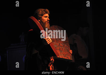 Actor dressed as Moses holding stage props of the Biblical Ten Commandments Stock Photo