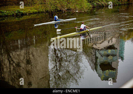 Rowing boats on the River Irwell  with the Civic Justice building reflecting int he water Stock Photo