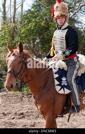 A trooper of Lord Uxbridge's 7th Hussars mounted on his horse preparing to ride to Waterloo Stock Photo