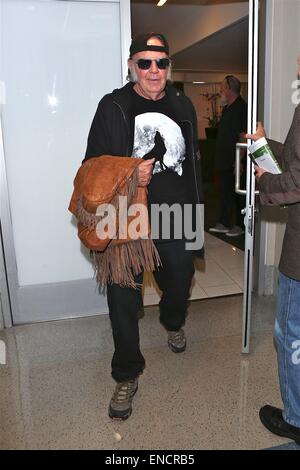 Neil Young wearing a howling wolf against a full moon t-shirt, leaves Los Angeles International Airport (LAX) and boards his tour bus  Featuring: Neil Young Where: Los Angeles, California, United States When: 28 Oct 2014 Stock Photo