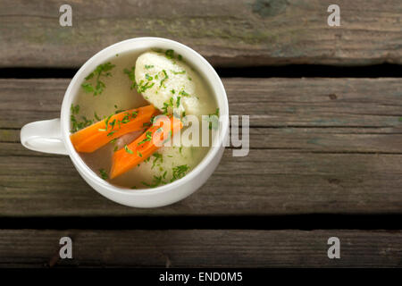 Soup with dumplings on a rustic wooden table Stock Photo