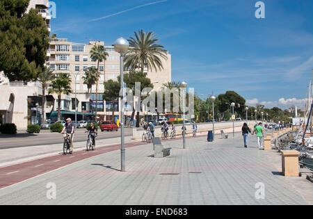 View near the harbor with bicyclists and walkers enjoying a warm sunny spring day on April 19, 2015 in Palma de Mallorca. Stock Photo