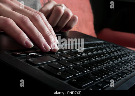 Hands typing on a laptop Stock Photo