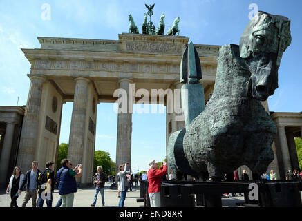 Berlin, Germany. 03rd May, 2015. Horse sculptures of the Mexcican artist Gustavo Aceves are presented in front of the Brandenburg gate in Berlin, Germany, 03 May 2015. 'Lapidarium - overcoming borders' - under this motto the Mexican wants to refer back to the quadriga horse and carriage on the gate using archaelogical remains to build the sculptures. Photo: BRITTA PEDERSEN/dpa/Alamy Live News Stock Photo