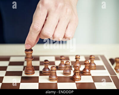 hand of a man moving a chess piece Stock Photo