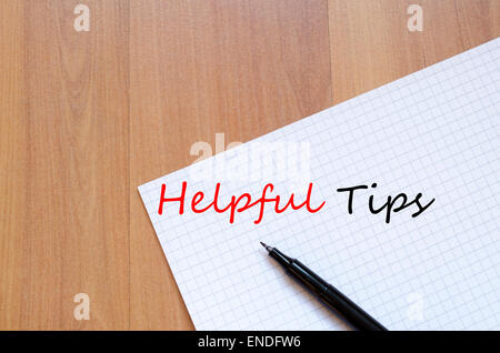 White blank notepad on office wooden table Helpful Tips concept Stock Photo