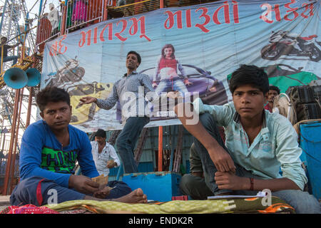 Young Man Dancing In Front Of Wall Of Death To Attract Clients, Vautha Mela Stock Photo