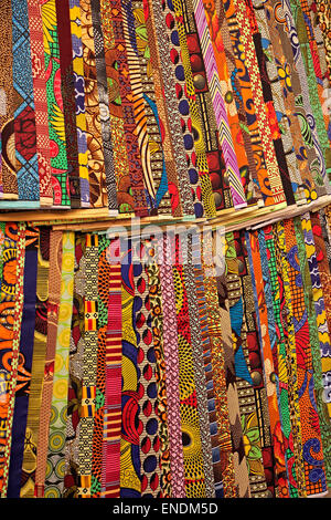 Colorful fabrics on display in a Stone Town street market, Zanzibar Stock Photo