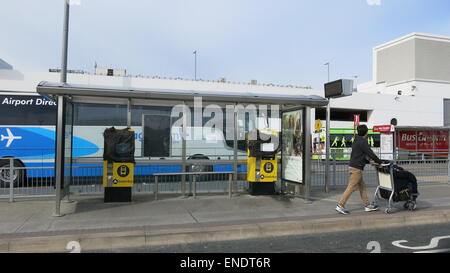 A commuter at an empty bus stop at  Dublin airport during a day of industrial action by drivers at Dublin Bus and Bus Eireann. Stock Photo