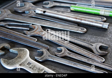 Still Life Close Up of Collection of Well-Used Metal Wrenches in Variety of Sizes on Work Tray Stock Photo