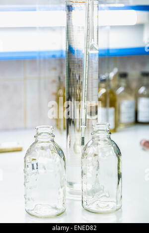 Empty glass bottles on table. Research laboratory glassware Stock Photo