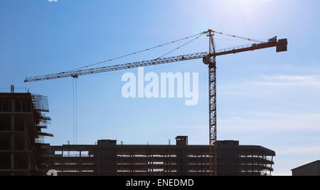 Construction crane on building site on sky background Stock Photo