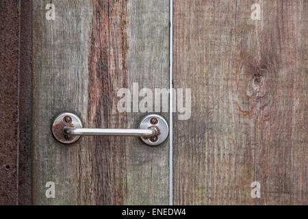 Metal rusty door handle on wood background Stock Photo