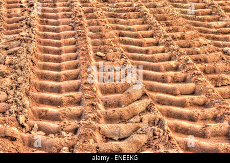 lots of deep truck tracks on the sand Stock Photo