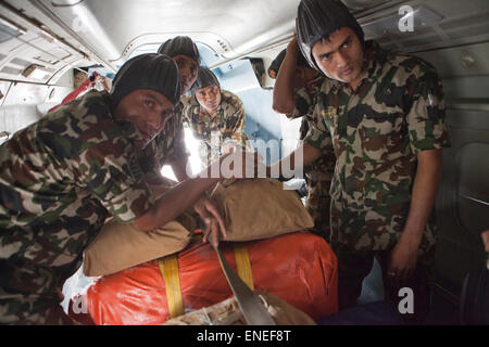 Nepal. 3rd May, 2015. Napoli Army prepare supplies for an air drop on a plane in Nepal. A major 7.9 earthquake hit Kathmandu mid-day on Saturday, April 25th, and was followed by multiple aftershocks that triggered avalanches on Mt. Everest that buried mountain climbers in their base camps. Credit:  PixelPro/Alamy Live News Stock Photo