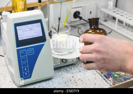 Laborant makes test in research laboratory with electronic measuring equipment on pharmaceutical industry manufacture Stock Photo