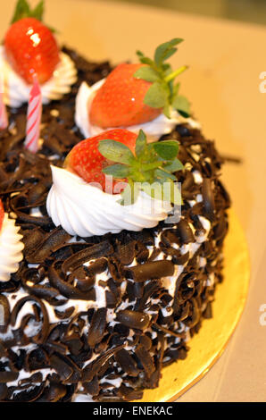 Happy Birthday candles on chocolate cake Stock Photo