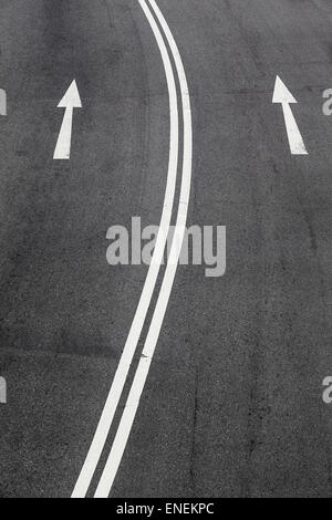 One-way signs and double middle lines on a road Stock Photo