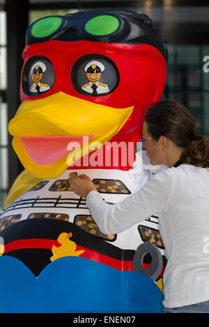 Colourful painted fibreglass model animal duck sculpture, Liverpool, Merseyside, 4rd May, 2015.  City Centre River Festival Project. A team of artists is decorating a host of giant ducks in public view at Mann Island Development.The Liverpool Duck Trail, commissioned by AquaDucked, is to be launched on LightNight to showcase the vibrant creativity alive in Liverpool. Stock Photo