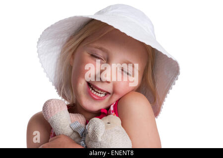 Portrait of a happy cute little girl hugging her toy animal on white background Stock Photo