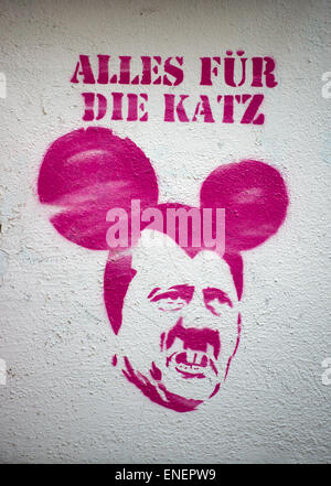 Dresden, Germany. 04th May, 2015. A pink grafitti depicting Adolf Hitler with Mickey Mouse ears beneath the words 'Alles für die Katz' (lit. all for the cat, a German saying which translates to 'it was all a waste of time') is seen in Dresden, Germany, 04 May 2015. Photo: Arno Burgi/dpa/Alamy Live News Stock Photo