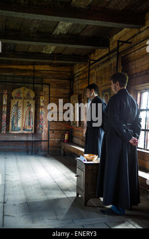Russia, Kishi island on the lake Onega, open air Museum of Karelian Wooden Architecture, Orthodox priests in the Assumption chur Stock Photo