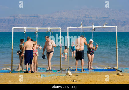 DEAD SEA, ISRAEL - OCT 13, 2014: People are taking a shower after they floated in the water of the dead sea in Israel Stock Photo